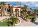 Inviting home exterior features a charming entryway with stone steps and lush greenery at 2540 Red Arrow Dr, Las Vegas, NV 89135