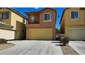 A two-story home featuring a two car garage, front porch, neutral toned stucco, and desert landscaping at 3634 Surfboard Ct, Las Vegas, NV 89147
