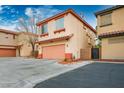 Exterior angle of a two story home with a two-car garage, featuring neutral colors and a well-kept yard at 3785 Corpolo Ave, Las Vegas, NV 89141