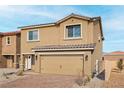Beautiful front exterior with a paved driveway leading to an attached two car garage at 4244 Golden Sol St, North Las Vegas, NV 89032