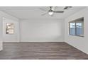 Spacious living room with hardwood flooring and natural light coming through multiple windows at 4244 Golden Sol St, North Las Vegas, NV 89032