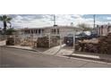 Street-level view of a home with gated yard and rock features adding to the home's curb appeal at 4701 Sacks Dr, Las Vegas, NV 89122