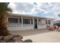 Property features a well-lit front porch, a brick-lined driveway, and unique yard ornaments at 4701 Sacks Dr, Las Vegas, NV 89122