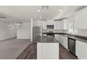 Bright kitchen boasts stainless steel appliances, a central island, and a view into the living area at 4940 Canna Lily St, Las Vegas, NV 89122