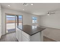 Open-concept kitchen with a view to the yard and living room with lots of natural light at 4940 Canna Lily St, Las Vegas, NV 89122