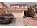 Charming two-story home featuring a two-car garage, desert landscaping, and a well-maintained front yard at 5032 Dancing Lights Ave, Las Vegas, NV 89130