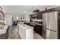Stylish kitchen featuring stainless steel appliances and a center island open to the living area at 5615 Distelrath Ave, Las Vegas, NV 89122