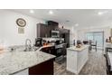 Modern kitchen with granite countertops, stainless steel appliances, and a central island at 5615 Distelrath Ave, Las Vegas, NV 89122