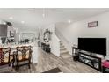 Open-concept living space with hardwood floors, ample natural light, and staircase to the second floor at 5615 Distelrath Ave, Las Vegas, NV 89122