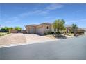Spacious home featuring a multi-car garage and brick driveway with manicured landscaping at 5812 Shangri La Night Ct, Las Vegas, NV 89149
