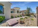 Inviting front entrance with brick pathway and beautifully landscaped yard at 5812 Shangri La Night Ct, Las Vegas, NV 89149