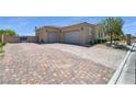 Large, brick driveway leading to a spacious multi-car garage at 5812 Shangri La Night Ct, Las Vegas, NV 89149