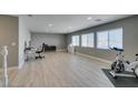 Bright, airy room with hardwood floors and multiple windows at 6220 Silver Edge St, North Las Vegas, NV 89031