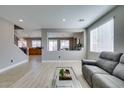 Bright living room featuring modern flooring, a stylish coffee table, and comfortable seating at 6220 Silver Edge St, North Las Vegas, NV 89031