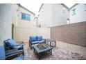 Private patio features a cozy seating arrangement with a fire pit, perfect for outdoor gatherings at 6913 Evening Orchid St, North Las Vegas, NV 89086