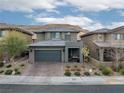 Charming two-story home featuring desert landscaping and a beautiful brick driveway at 7023 Amethyst Peak St, Las Vegas, NV 89148