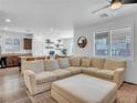 Bright living room with hardwood floors, modern fan, and lots of natural light at 7023 Amethyst Peak St, Las Vegas, NV 89148
