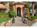 Stunning front entrance with manicured landscaping and elegant lighting fixtures at 8455 Stange Ave, Las Vegas, NV 89129