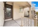 Cozy, covered front porch with decorative iron railing and a stylish front door that welcomes guests at 9132 Gabardine Ave, Las Vegas, NV 89149