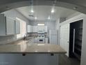 Eat-in kitchen features granite countertops, white appliances, and ample storage space in white cabinets at 9592 Villa Calera Ave, Las Vegas, NV 89148