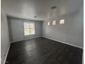 Bright and spacious living room with hardwood floors, filled with natural light from the large windows at 9592 Villa Calera Ave, Las Vegas, NV 89148