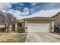 Charming single-story home featuring a two-car garage and desert landscaping under a cloudy sky at 9844 Altadena St, Las Vegas, NV 89183