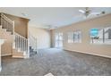 Spacious living room with neutral tones, ceiling fans, and sliding door access to outdoor space at 1142 Heavenly Harvest Pl # 2, Henderson, NV 89002