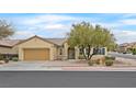 Inviting single-story home featuring a neat front yard with xeriscape landscaping and an attached garage at 2084 Fort Halifax St, Henderson, NV 89052