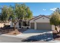 Attractive single-story home featuring a three-car garage and desert landscaping at 2156 Twin Falls Dr, Henderson, NV 89044