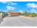 Single story home features a desert front yard, two-car garage, and gated RV parking at 2302 Wagonwheel Ave, Las Vegas, NV 89119