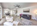 Bright living room featuring neutral tones, modern furnishings, ceiling fan, and a view into dining area at 2834 Natalie Ave, Las Vegas, NV 89121