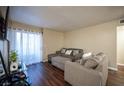 Cozy living room with modern decor and sliding door access to the outside at 2969 Juniper Hills Blvd # 103, Las Vegas, NV 89142