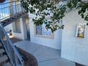 Sidewalk leads to unit entrance with stairs and exterior window at 3318 N Decatur Blvd # 1056, Las Vegas, NV 89130