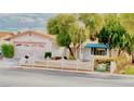Charming single-story home with mature trees and a well-maintained white picket fence at 3572 Tempe St, Las Vegas, NV 89103