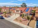 Beautiful home featuring a terracotta tile roof, solar panels, desert landscaping, and an attached three-car garage at 37 Stone Cress Dr, Henderson, NV 89074
