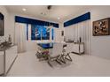 Elegant dining room features modern chandelier, large windows and seating for six at 4087 Villa Rafael Dr, Las Vegas, NV 89141