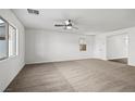 Bright, carpeted living room with natural lighting and a ceiling fan; perfect for entertaining or relaxing at 4245 Gold Desert St, North Las Vegas, NV 89032