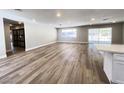 Bright and airy living room featuring light wood floors, recessed lighting and sliding glass doors at 4485 Greenhill Dr, Las Vegas, NV 89121