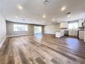 Spacious living room featuring wood floors, recessed lighting and kitchen with stainless steel appliances at 4485 Greenhill Dr, Las Vegas, NV 89121