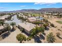 Aerial view of a single-story home, showcasing the desert landscaping and nearby mountains at 4963 Pensier St, Las Vegas, NV 89135