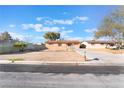 Charming single-story home featuring a desert landscape, driveway, and secure chain-link fence at 4970 E Van Buren Ave, Las Vegas, NV 89110