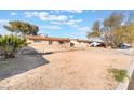 Quaint single-story home with a fenced yard and desert landscaping, offering a blank canvas for customization at 4970 E Van Buren Ave, Las Vegas, NV 89110