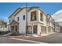 View of townhome featuring multi-story design with an attached garage, street view, and well-maintained landscaping at 524 Teovani St # 826, Henderson, NV 89052