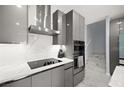 Close up view of kitchen appliances, including range and hood, plus built-in oven and microwave at 528 Thistleberry Ave, Henderson, NV 89044