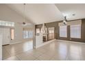 Inviting living room with vaulted ceilings, fireplace, and large windows providing natural light at 7228 Buglehorn St, Las Vegas, NV 89131