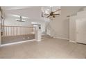 Spacious living area showcasing tile floors, soaring ceilings, and staircase leading to the upper level at 7228 Buglehorn St, Las Vegas, NV 89131