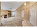 Bright living room with neutral carpet, fireplace, and ample natural light at 7772 Buckwood Ct, Las Vegas, NV 89149