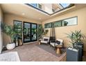 Cozy outdoor patio with comfortable seating, stylish planters, and seamless transition to the home's interior at 80 Pristine Glen St, Las Vegas, NV 89135