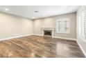 Bright living room showcasing wood floors, modern fireplace and shuttered windows at 8224 Crystal Star Ct, Las Vegas, NV 89145