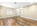 Open-concept living room with staircase, wood floors, and natural light at 8224 Crystal Star Ct, Las Vegas, NV 89145